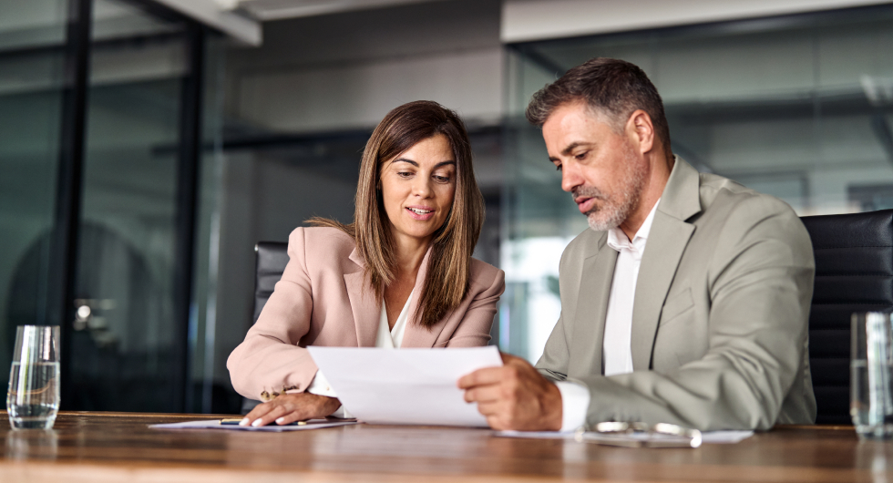 Two people redlining a contract.